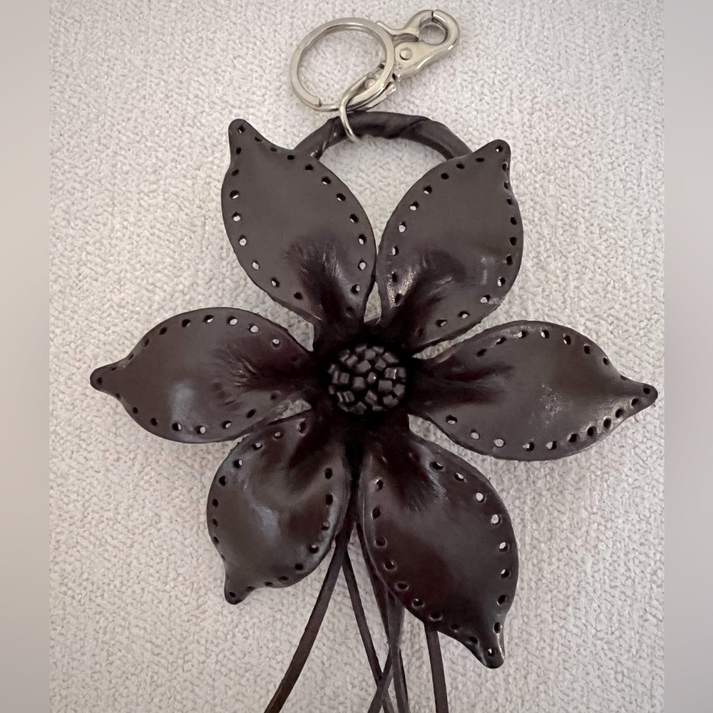 Handmade leather dark brown flower bag charm with silver color hardware.
